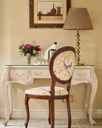 French-style dressing table set features a cream-colored console desk with delicate floral upholstery on the chair