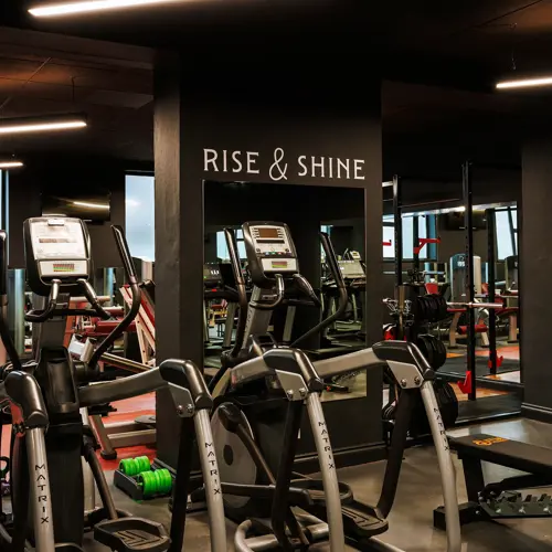 The Rise & Shine gym features a modern indoor fitness space equipped with professional Matrix cardio machines