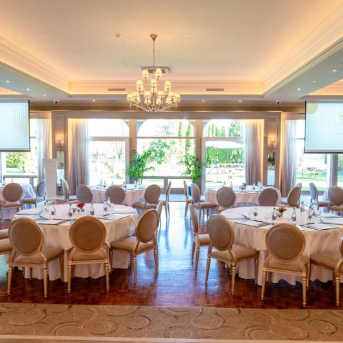 Elegant ballroom, the Ballyhannon Suite at The Rine, featuring natural light and a classic chandelier.