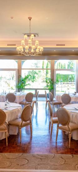 Elegant ballroom, the Ballyhannon Suite at The Rine, featuring natural light and a classic chandelier.